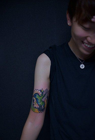 hummingbird tattoo picture of a woman's small arm 18579 - a black and white arm tattoo combined with a prajna and a Buddha