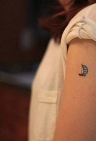 female arm sailing small tattoo