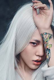 La forma de bruixa de pèl blanc de Wu Mo Zhen, mostra un tatuatge pintat de braç