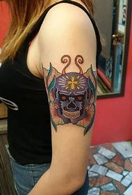 female arm skull butterfly tattoo