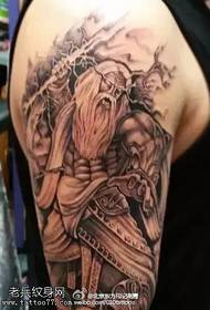 Zeus tattoo on the macho arm