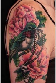 Картина красивая птичка и цветок тату на руке девушки