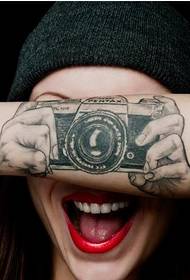 Recommend a unique arm camera tattoo picture