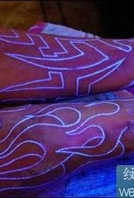 Fluorescent totem tattoo on the arm