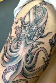 Groot zwart-wit octopuspatroon op de arm met een kroon met een scepter
