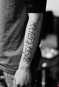 Black and white arm English tattoo