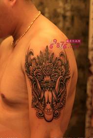 Tribal Chief mask arm tatuering bild