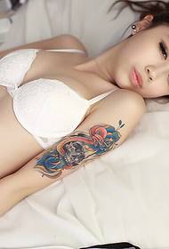 躺在床上的新鮮美女展示手臂紋身圖片