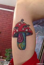 Colored mushroom tattoo pattern on the inside of the arm