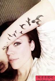 Braccio donna ingoiare il tatuaggio
