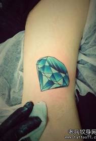 Een kleurrijk diamanten tattoo-patroon aan de binnenkant van de arm van de mooie vrouw