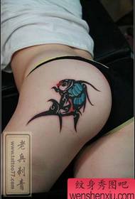 a totem fish tattoo pattern on the hips