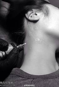 fluorescent cherry blossom tattoo on the neck