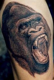 Realistic black and white gorilla head tattoo on the thigh