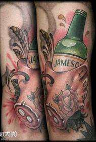 ben, der holder et øl-tatoveringsmønster