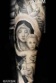 Legs of the model of tattoo of Virgin Child