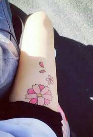 small fresh cherry blossom tattoo on the thigh is very beautiful