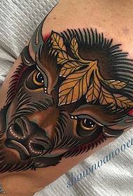 a cow tattoo on the knee