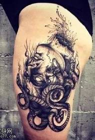 Snake girl tattoo on the thigh