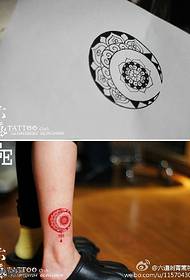 Bright and beautiful red Brahma tattoo pattern on the ankle