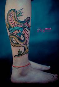 Foto de tatuaje de cobra y ojo de dios