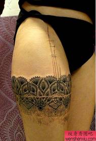 a sexy lace flower arm tattoo on the thigh