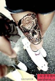 a woman's leg skull tattoo pattern