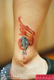 Legs with small diamonds and wings tattoos
