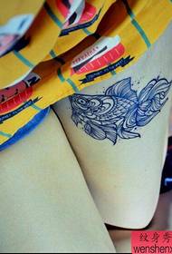 Sievietes kājas zivju tetovējumi