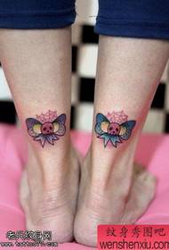 Colorful bows and tattoos on the legs