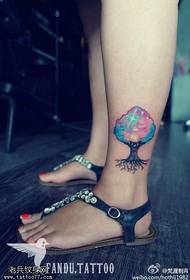 woman's ankle-colored starry tree tattoos