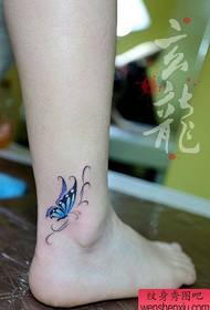 女孩腳踝處的小巧且流行的蝴蝶紋身圖案