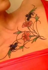 clavicle flowers with black bird tattoo pattern