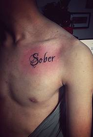 simple low-key chest English tattoo