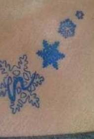 a pair of colored snowflake tattoos on the chest