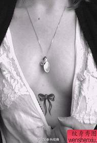 Piccoli tatuaggi con fiocco sul petto freschi da donna