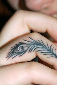 Little peacock feather tattoo pattern on girl finger