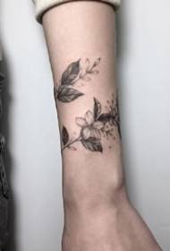 Flower vine tattoo pattern wrapped around the wrist of the small arm