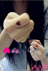 Girl finger personality red heart tattoo picture