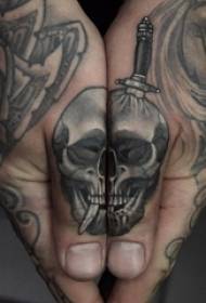 skull tattoo, male student finger on dagger and skull tattoo picture