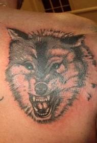 Черное тату с изображением головы волка