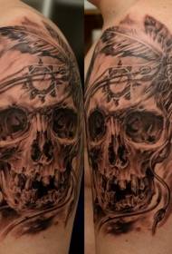 Gorgeous black and white skull and feather tattoo on the shoulder