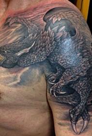 Forferdelig svart tatoveringsmønster på dragen på skulderen