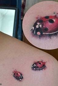 Cute seven-spot ladybug tattoo on the shoulder