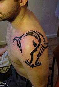 Handsome totem tattoo on the shoulder
