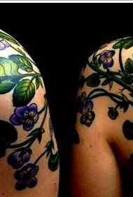 Couple shoulders with the same bee and plant tattoo pictures