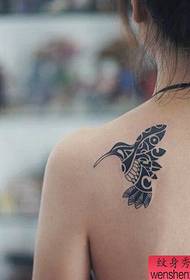 Woman shoulder hummingbird tattoo work