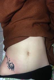 small pattern tattoo that falls on the waist of the girl