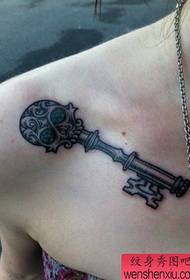 Woman shoulder skull key tattoo work