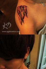 Cool dagger tattoo on the shoulder of the girl
